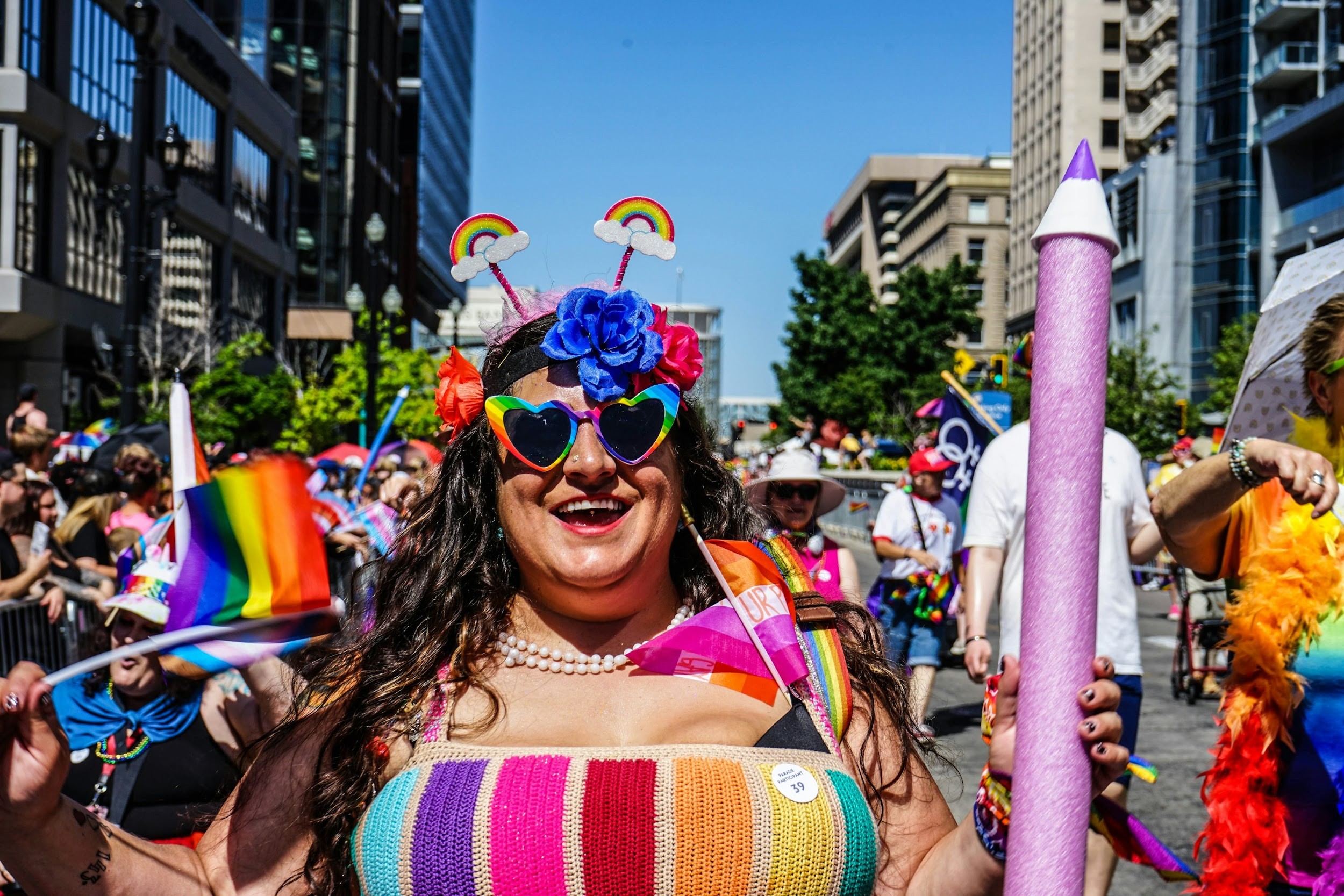 People celebrate pride with colorful outfits and flags.